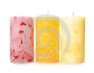 Three color wax candles on white