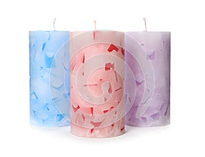 Three color wax candles on white