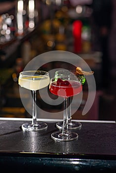 Three colored cocktails on the bar.