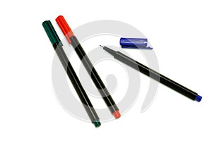 Three colored felt pencils isolated on white background. Red, green and blue. Blue pen with sharp tip and cap off