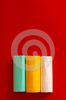 Colored garbage bags roll on gray background