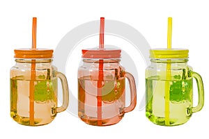 Three colored glass glasses with tubes, orange, red and green, on a white background, isolated