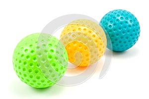 Three colored golf balls