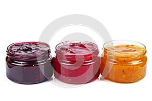 Three colored jam in glass jare isolated on a white