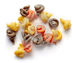 Three-colored pasta on white, from above