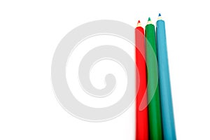 Three colored pencils. The colors red, green and blue. The concept of polygraphy and digital RGB color transfer