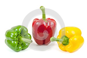 Three colored peppers on white background