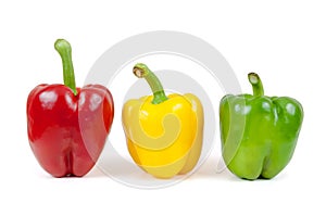 Three colored peppers on white background