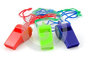Three colored plastic whistles