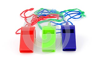 Three colored plastic whistles