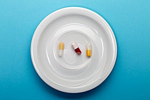 Three colorful capsules on a plate