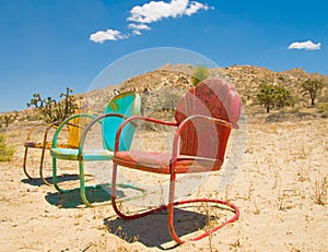 Three Colorful Chairs Forgotten in the Desert