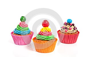 Three colorful creamed cupcakes