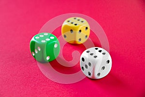 Three colorful dices isolated on pink