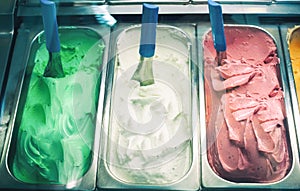 Three colorful flavour ice-cream in shop close up