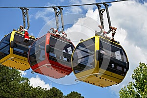 Three colorful gondolas cable cars as they transport people up and down in the Caracol Park, Brazil