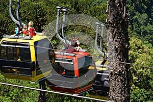 Three colorful gondolas cable cars as they transport people up and down in the Caracol Park photo