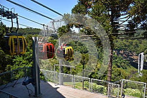 Three colorful gondolas cable cars as they transport people up and down in the Caracol Park photo