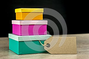 Three colorful nesting gift boxes and tag