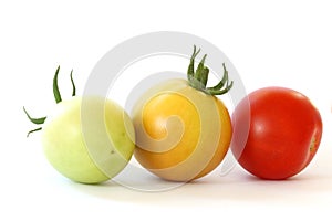 Three colorful tomatoes on white background