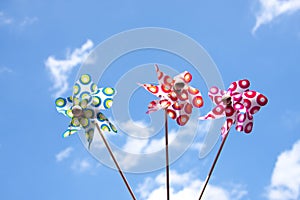 Three colorful windmill toys