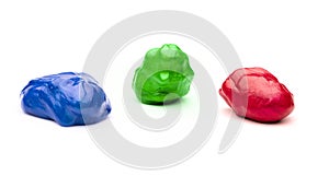 Three colourful plasticine spheres of red, green and blue.