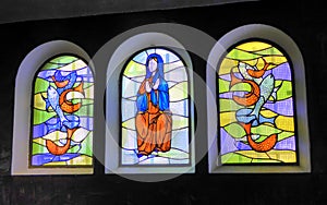 Three colourful stained glass windows