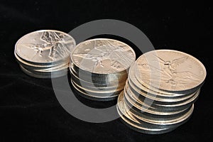 Three columns of silver coins photo