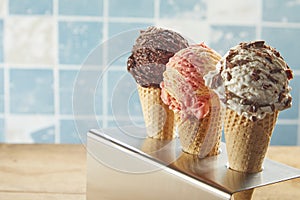 Three cones of assorted ice cream in a holder