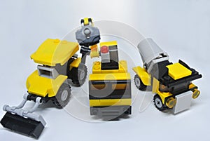 Three construction heavy machine toys made from plastic blocks