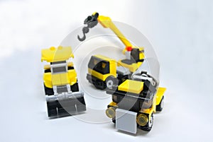 Three construction heavy machine toys made from plastic blocks