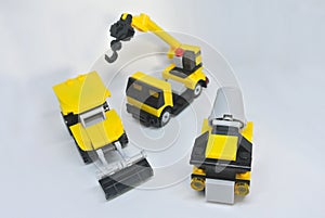 Three construction heavy machine toys made from plastic blocks