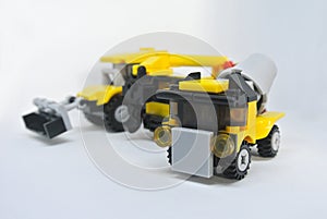 Three construction heavy machine toys made from plastic blocks