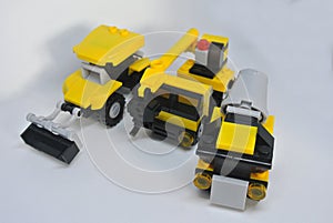 Three construction heavy machine toys made from plastic blocks