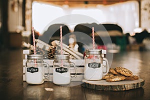 Three containers of milk and cookies