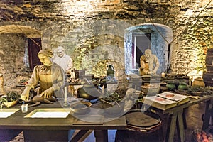 Three cooks prepare ingredients in the Great Kitchen for the next meal, Stirling Castle