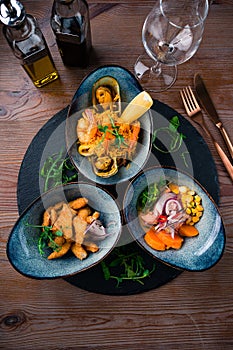 three-course set of salmon ceviche, seafood rice and fish chicharones photo