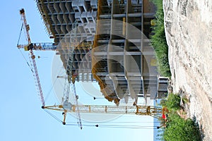 Three cranes on building