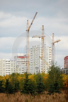 three cranes on top of high-rise building