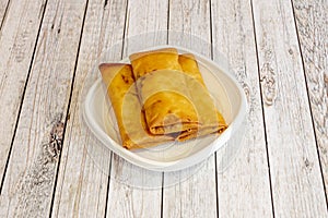 three crispy Chinese spring rolls fried in olive oil