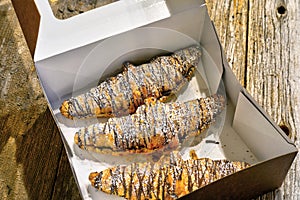 Three croissants on on rustic table