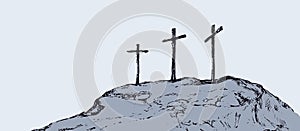 Three crosses stand on light sky backdrop