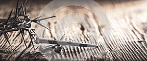 Three Crucifixion Spikes Wooden Table With Crown Of Thorns photo