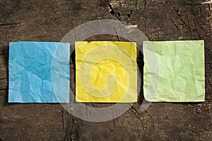 Three crumpled blank note papers in different colors