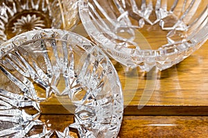 Three crystal vases on light wooden surfaces