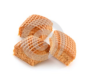 Three cubes of checkered creamy toffee close-up isolated on white background