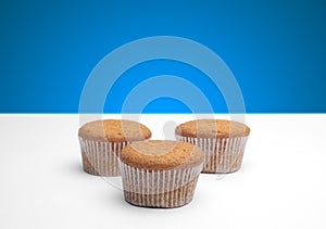 Three cupcakes on a wooden table