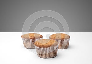 Three cupcakes on a wooden table