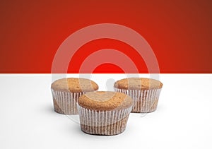 Three cupcakes on a wooden table