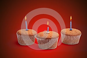 Three cupcakes on a wooden table